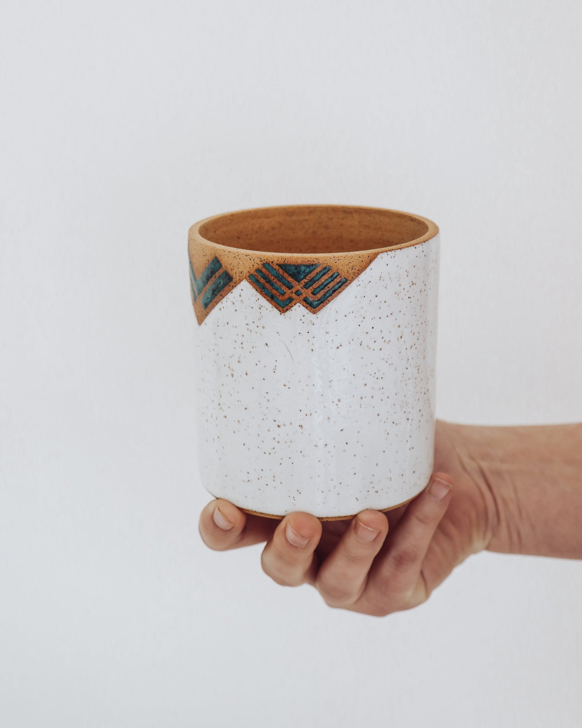 Side view of white and turquoise art deco planter handmade by Crisp Ceramic on a potters wheel. 