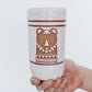 Hand Holding a handmade speckled ceramic tumbler featuring a brown illustrated bear design with geometric detailing. 