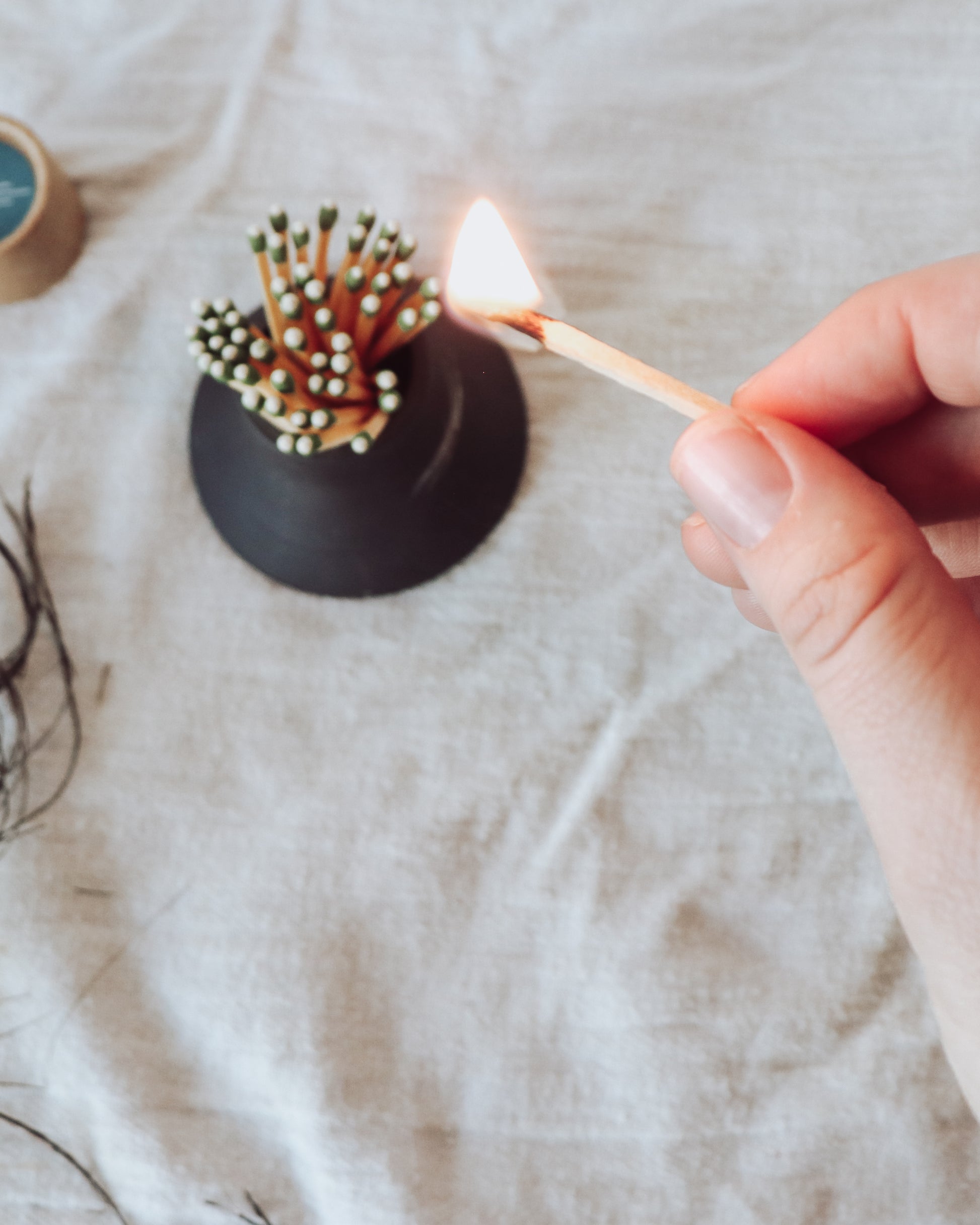 Black match striker pottery - Slate Crisp Ceramic match striker being lit from above.