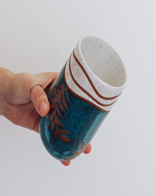 Side View of Pottery leaf tumbler. Hand thrown green pottery leaf tumbler with white tropical style top. Pottery by Crisp Ceramic in Los Angeles.