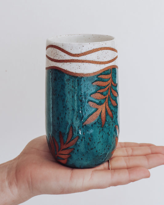 Pottery leaf tumbler. Hand thrown green pottery leaf tumbler with white tropical style top. Pottery by Crisp Ceramic in Los Angeles.